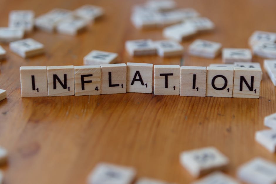 Wooden tiles spelling INFLATION representing rising prices